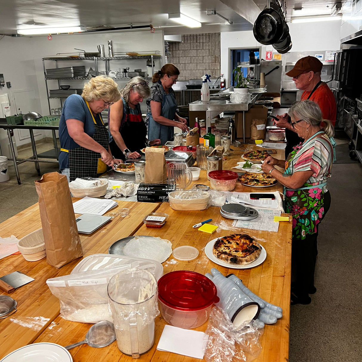 Sourdough Class cutting into baked pizza for lunch