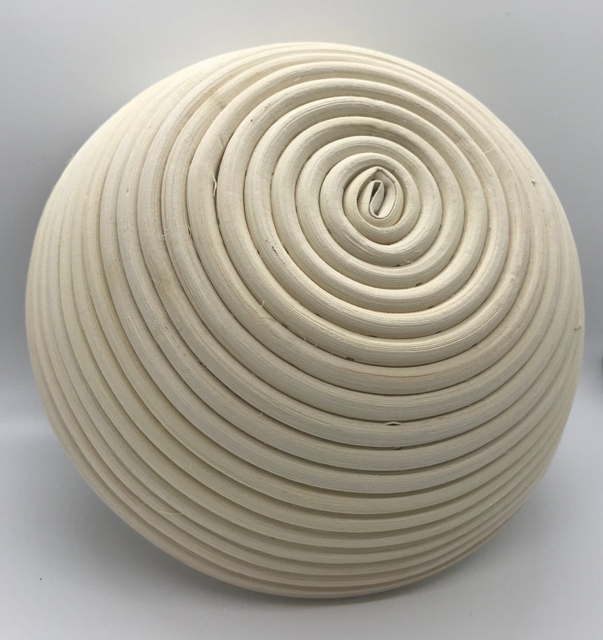 Bottom Close-up of natural rattan proofing basket spiral pattern