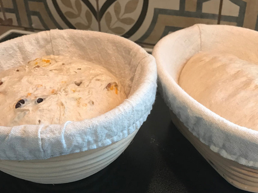 Close-up of sourdough dough proofing in round and oval rattan banneton