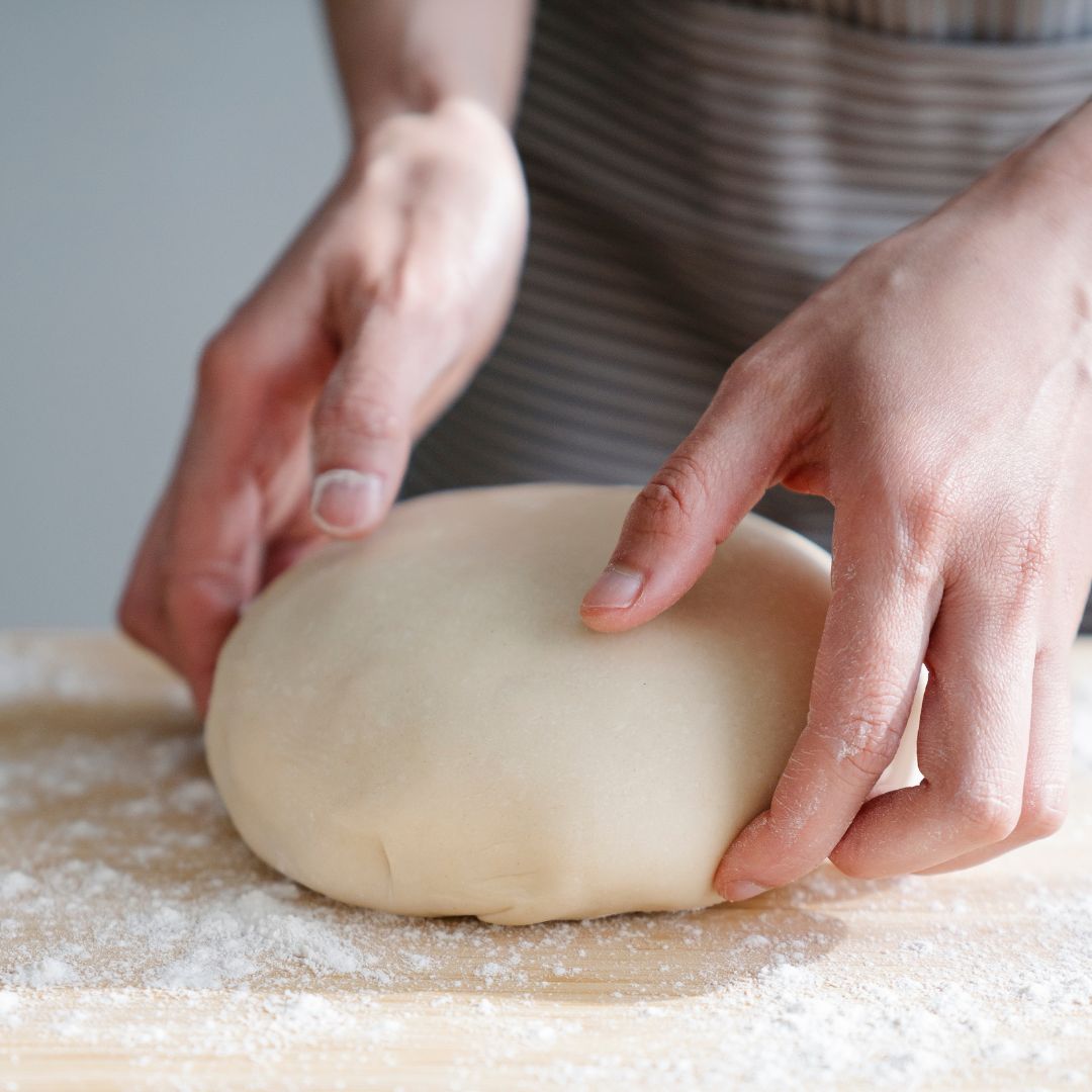 hands shaping sourdough