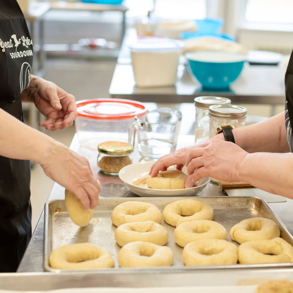 2 people seeding bagels