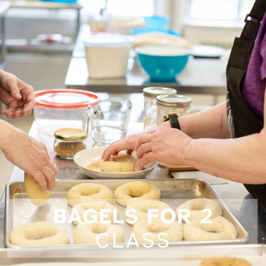 Two people seeding rolled bagels
