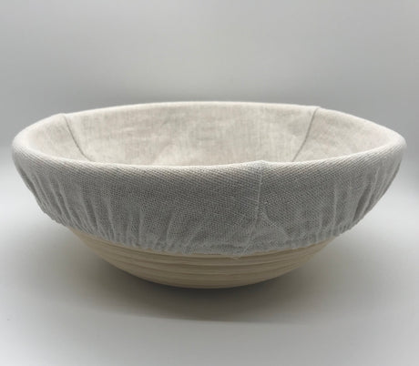 Side view of 9 inch sourdough proofing basket with dough inside