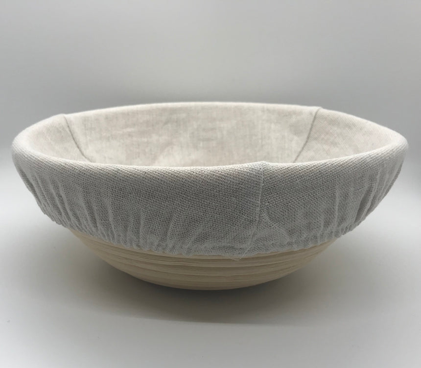 Side view of 9 inch sourdough proofing basket with dough inside